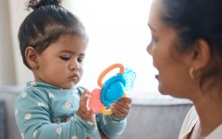 Shot of an adorable little girl playing with a toy while bonding with her mother